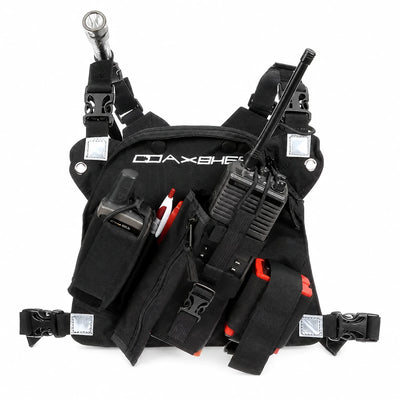 Black wildland radio chest harness pack with adjustable straps, pockets, and pull tabs.